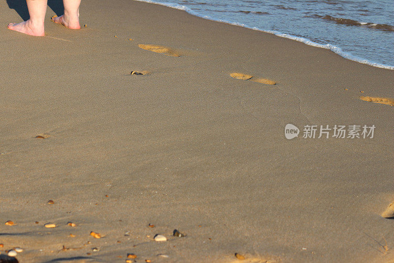 沙滩上的脚印，海边的脚印，光着脚的女孩/腿